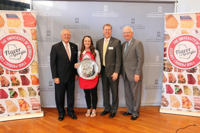 Amanda Wilbanks, owner of Southern Baked Pie Co. in Gainesville, accepts her University of Georgia Flavor of Georgia grand prize trophy from Gov. Nathan Deal; Sam Pardue, dean and director of the UGA College of Agricultural and Environmental Sciences; and Georgia Agriculture Commissioner Gary Black. (Photo courtesy of Merritt Melancon, University of Georgia)