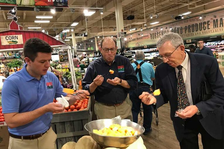 New Jersey Agriculture Secretary Douglas H. Fisher, center, samples Jersey Fresh cantaloupe at the ShopRite of Greater Morristown with Bob Sumas, right, president of Village Super Market Inc., and Tom Beaver, director of marketing and development for the New Jersey Department of Agriculture.