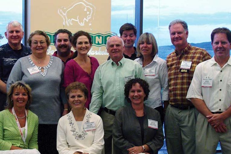 Oleson’s management team includes Marty Watts (front left), DJ Oleson and Brad Oleson (standing far right).