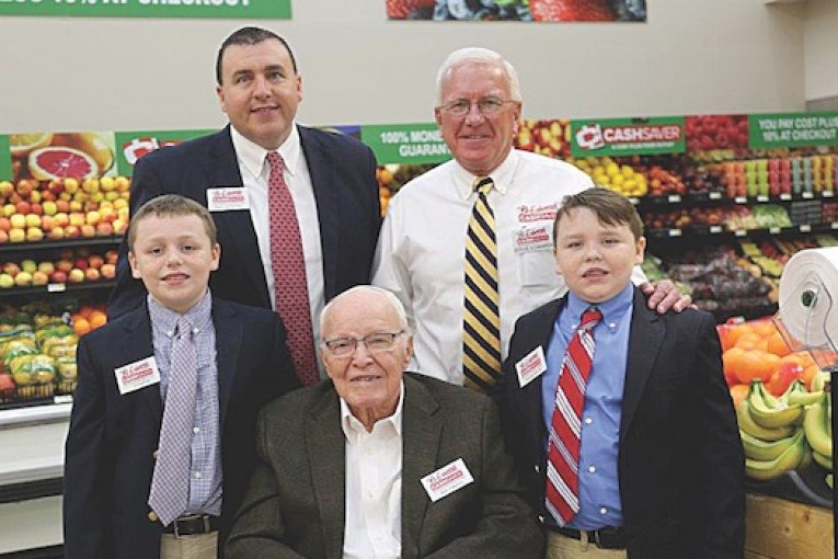 Grandsons J.P. Rowton, left, and William Rowton, right, flank their great-grandfather Oral Edwards; back, from left, Paul Rowton, company VP, with his father-in-law, company president Steve Edwards.