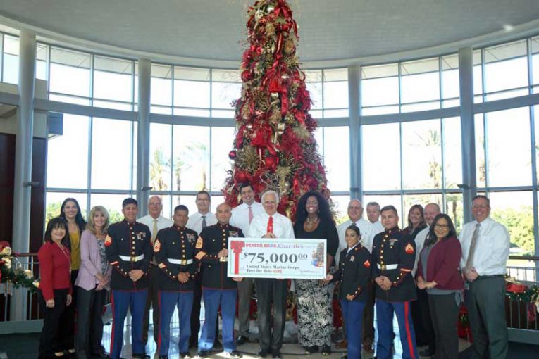 representatives from Stater Bros. gathered to present a $75,000 check to local Toys for Tots Program ambassadors.