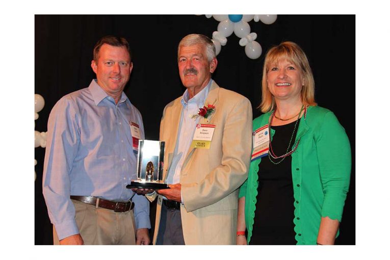 MGA Board Chairman Mark Collier; Dean Simpson; MGA President Jamie Pfuhl.