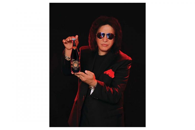 Gene Simmons holding a Money Bag soda bottle