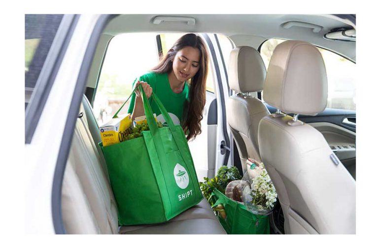 A Shipt shopper loading groceries into her car