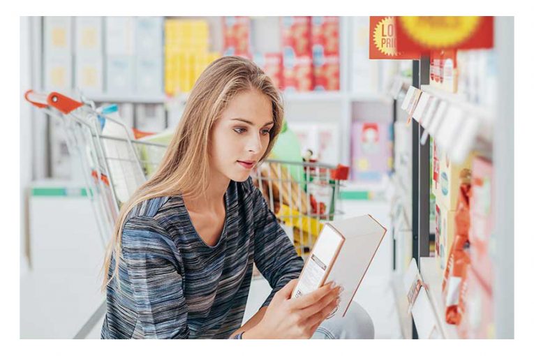 A woman reading a product label