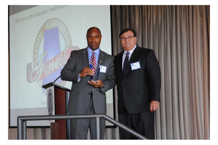 Curtis Lyons receives the vendor of the year award from Frank D'Amico III.