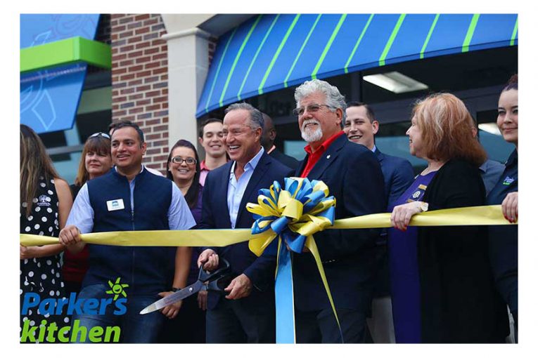 Parker’s President and CEO Greg Parker, center, and Pooler Mayor Mike Lamb, right of center, cut the ribbon at the new store.