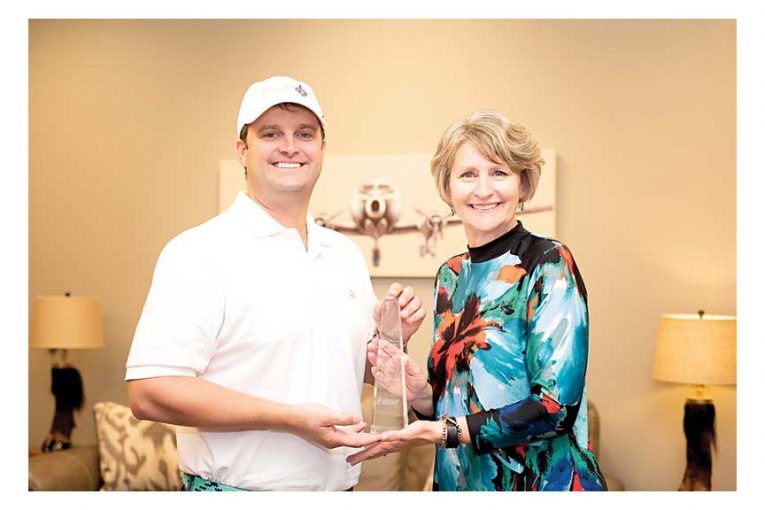 Presenting the award to CEO Donny Rouse.