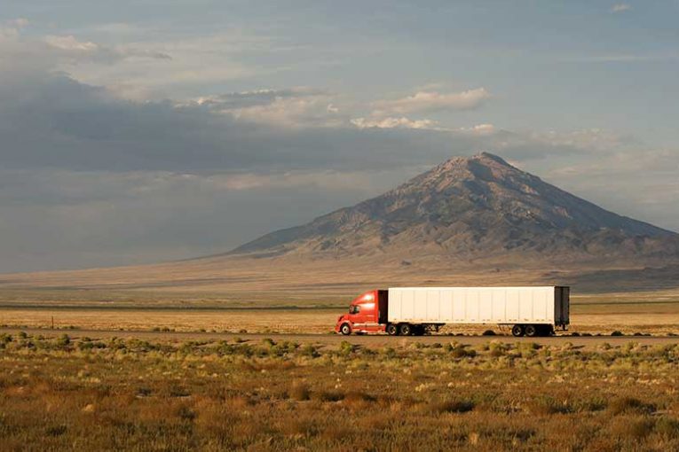 A photo of a truck on the road.