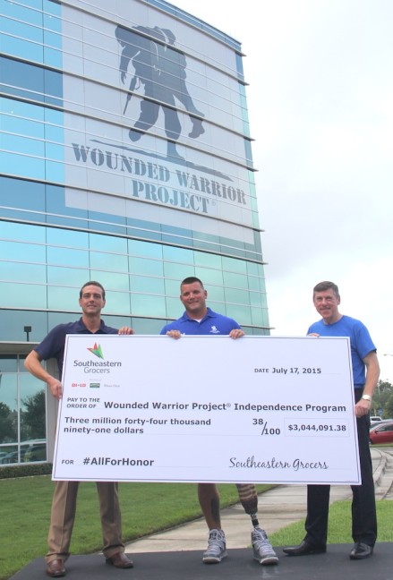 BI-LO, Harveys and Winn-Dixie President and CEO Ian McLeod, right, presents Steve Nardizzi, CEO of Wounded Warrior Project, left, and Wounded Warrior Sean Karpf with a $3,044.091.38 donation check to the Wounded Warrior Project’s Independence Program.
