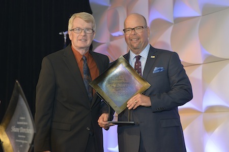 AFMA President Tim McCabe presents Terry Morrison of Crescent Crown Distributing with the Supplier of the Year Award.
