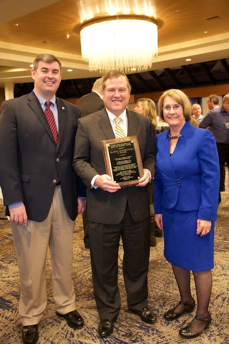 Washington State Rep. J.T. Wilcox, center, was presented the Spirit of America Award by Greg Ferrara of the National Grocers Association and Jan Gee, president and CEO of the Washington Food Industry Association. 
