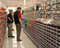 Tom Coogle meets with staff in the Ace Hardware section.