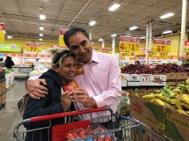 Joe Villareal, director of retail operations, Joe V’s, hugs a shopper who just received a gift card during the reopening celebration in January that followed remodeling work.