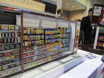 The miniature store aisle illustrates how to display items like gums and mints horizontally and vertically.